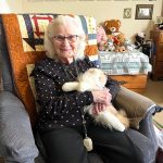 Photos by Matthew N. Wells / The Daily World
Betty Bullock turned 100 on Nov. 29, and she spoke about her remarkable life. She flew in a plane in 1932, lived in France and West Germany for years, and she raised seven children with her husband Carl. Behind Bullock are her childrens high school graduation photos. Shes holding Ozzie, her stuffed cat, whom she loves dearly.