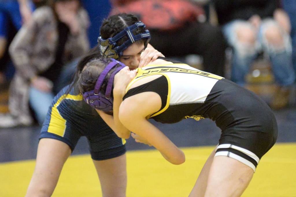 RYAN SPARKS | THE DAILY WORLD Aberdeens Alondra Santibanez, left, grapples with Llincolns Olivia Mounts during the 100-pound final of the Grays Harbor Championships on Saturday in Aberdeen.