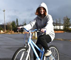 Matthew N. Wells / The Daily World 
Riley Gilbert, 14, received her first Christmas gift  a new bike  Saturday. Riley, who hasnt had a new bike in a couple of years, rode her North Carolina Tar Heel-painted bike around as she and her mom, Kim, smiled. The bike is courtesy of the Aberdeen Lions Clubs program Bicycles from Heaven, which, after a simple application through the Salvation Army, provides children and teenagers bikes. Riley cant wait to show hers off to her friends.