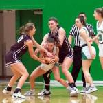 JOSH KIRSHENBAUM | THE CHRONICLE Montesanos Mikayla Stanfield, left, and McKynnlie Dalan swarm Tumwaters Regan Brewer during the second half of Montes 37-21 win on Thursday in Tumwater.