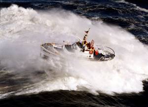 Larry Kellis / USCG 
A U.S. Coast Guard 52-foot Motor Lifeboat crashes through a wave in the Pacific Ocean. The services is currently weighing how to replaces the vessels, which were in service for nearly 60 years.