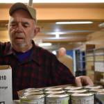 Clayton Franke / The Daily World 
Mike Barkstrom, volunteer at the Salvation Army food pantry in Aberdeen, stocks shelves Dec. 15.
