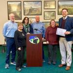 Ryan Leo, right, a new harbor pilot for the Port of Grays Harbor, accepts a certificate as part of the process of becoming licensed, an extremely involved series of evaluations. (Courtesy photo / Port of Grays Harbor)