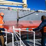 Ryan Leo, left, a new harbor pilot for the Port of Grays Harbor, prepares to board a ship during the tricky process of transferring. Director of Pilotage Bobby DAngelo can be seen climbing the ladder. (Courtesy photo / Jeremy Johnson)
