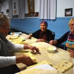 Haldis Totland, Jane Louzan and Ella Seely, from left to right, slather creamy butter onto the Lefse before folding it. While they worked, they happily shared stories, talked about the societal difficulties upon immigrating to the United States and called for more butter when they ran out. Dixie Thompson, lodge president of the Sons of Norway Grays Harbor, championed Totland and Seelys skillset in making Lefse. Ella and Haldis are both from Norway and they know how to do everything, Thompson said. (Matthew N. Wells / The Daily World)(Matthew N. Wells / The Daily World)