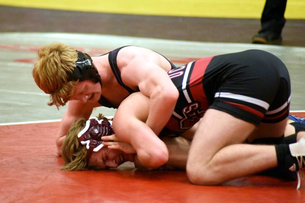 PHOTO BY SUE MICHALAK BUDSBERG Ocostas Andrew Martin, bottom, and Willapa Harbors Carson Borden compete in the 145-pound championship match of the Grizzly Alumni Invitational on Saturday in Hoquiam. Martin won via 9-6 decision.