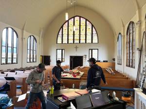 Matthew N. Wells / The Daily World 
Workers from Cathedral Crafts Stained Glass Company, out of Winona, Minnesota, work in order to complete the restoration of the 99-year-old stained glass windows at Amazing Grace Lutheran Church of Grays Harbor. The clear windows on the left side show the unfinished bits of restoration, which should be completed this week.