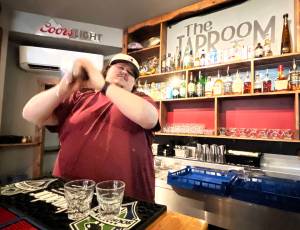 Bryce Romero, proprietor of The Tap Room  103 East Wishkah St., in Aberdeen  shakes a couple of drinks Tuesday early afternoon for thirsty customers. Romero often uses those skills to make the Green Tea shot, and hand-crafted cocktails. While Romero isnt sure where the Jameson-based drink came from, he said his place is in the running for the best one in town. (Matthew N. Wells / The Daily World)