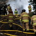 Firefighters climb towards a structure fire that broke out on Dec. 13, 2022 outside of Aberdeen. (Michael S. Lockett / The Daily World File)