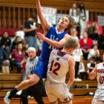 PHOTO BY FOREST WORGUM Elmas Traden Carter (10) drives to the basket against Hoquiams Michael Lorton Watkins (12) during the Grizzlies 60-51 win on Friday at Hoquiam Square Garden.