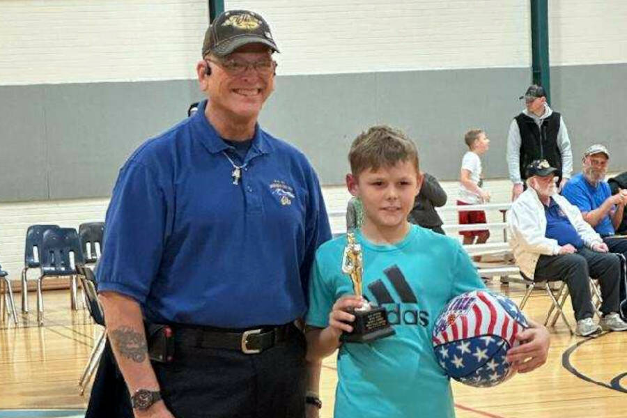 SUBMITTED PHOTO Lawyer Niemi, right, is presented with the Elks Hoop Shoot district championship in the boys 10-11 division by Elks Hoop Shoot District Director Syd Nunez on Saturday in Port Angeles.
