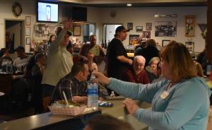 Arguably the main appeal of the Baked Potato Feed and Dollar Auction fundraiser for the Grays Harbor Timberwolves on Saturday, Jan 21, in Aberdeen, came from the unique lottery-style live auction. Beth Torseth (light blue shirt) led the auction and gave bidders their numbers depending on how many dollars they were willing to give. (Allen Leister / The Daily World)