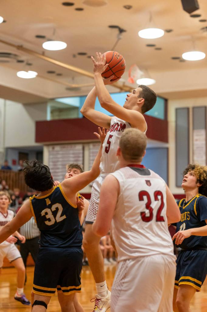 PHOTO BY FOREST WORGUM Hoquiams Owen McNeill (5) puts up a jump shot over Aberdeens Kenny Dawson, left, during the Grizzlies 67-38 win on Friday at Hoquiam High School.