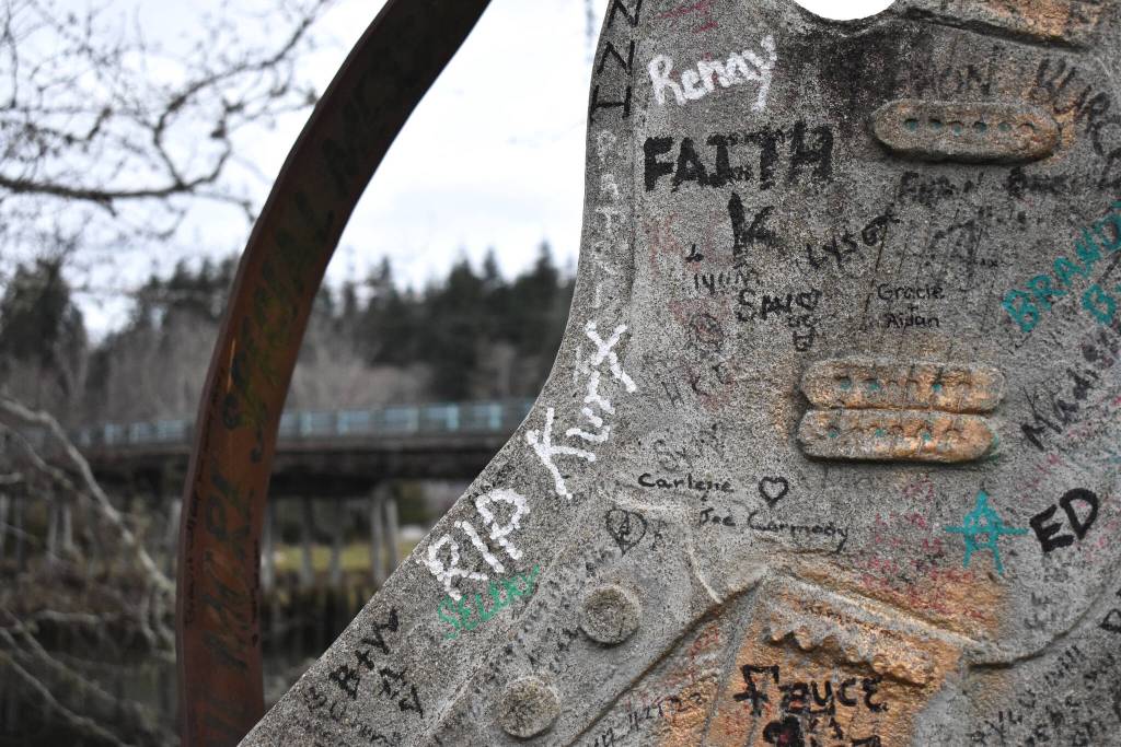 RIP Kurt, is among a large collection of inscriptions that are penned, marked, or spray painted, on the guitar statue at Kurt Cobain Memorial Park, in North Aberdeen. The park, with the bridge seen behind the guitar, sits at the base of the Young Street Bridge. The bridge is slated to come down in the next few years after the city of Aberdeen received $25 million to replace it. (Matthew N. Wells / The Daily World)