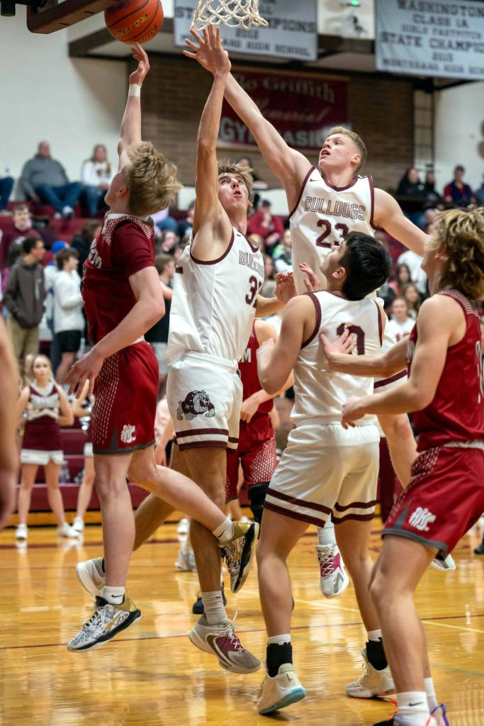 PHOTO BY FOREST WORGUM Montesanos Tyce Peterson (23) and Soren Cobb defend against Hoquiams Michael Lorton Watkins, left, during the Grizzlies 54-28 win on Thursday in Montesano.
