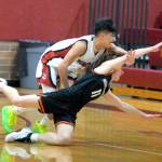 RYAN SPARKS | THE DAILY WORLD Ocostas Josh Figueroa, top, chases a loose ball against Rainiers Jimmy Meldrum during the Wildcats 64-62 loss in the first round of the 2B District 4 Tournament on Saturday at Montesano High School.