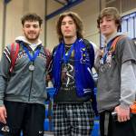 SUBMITTED PHOTO
Montesano wrestlers Mateo Sanchez, left, and Cole Ekerson, right, flank Elmas Austin Salazar at the conclusion of the 1A Evergreen sub-district meet on Saturday at Eatonville High School. The three Harbor student-athletes were named co-Outstanding Wrestlers for the league.