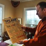 John Larson, Polson Museum's director, holds a Splash Festival poster from 1938. The poster is one of many items of Grays Harbor history that people might find interesting. While the museum is not open for tours until April, Larson and his staff are working hard to make sure it's in the best shape for a public open house April 1. (Matthew N. Wells / The Daily World)
