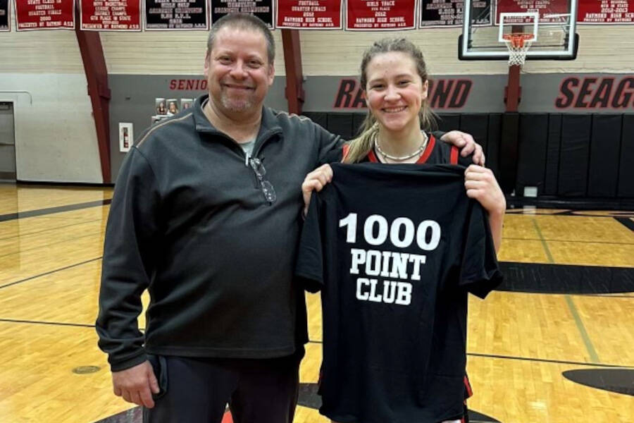 SUBMITTED PHOTO Raymond sophomore Karsyn Freeman, right, poses for a photo with head coach Jason Koski after scoring her 1,000th point in a game against Adna on Tuesday.