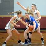 RYAN SPARKS | THE DAILY WORLD Montesanos Mikayla Stanfield, left, and McKynnlie Dalan swarm La Centers Talia Wise during the Bulldogs 67-5 victory in the first round of the 1A District 4 Tournament on Thursday in Montesano.
