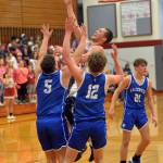 RYAN SPARKS | THE DAILY WORLD Hoquiam senior Justice Stankavich shoots against La Centers Clayton Muffett (5) and Austin Nixon (12) during the Grizzlies 86-57 victory in the 1A District 4 Tournament on Friday in Hoquiam.