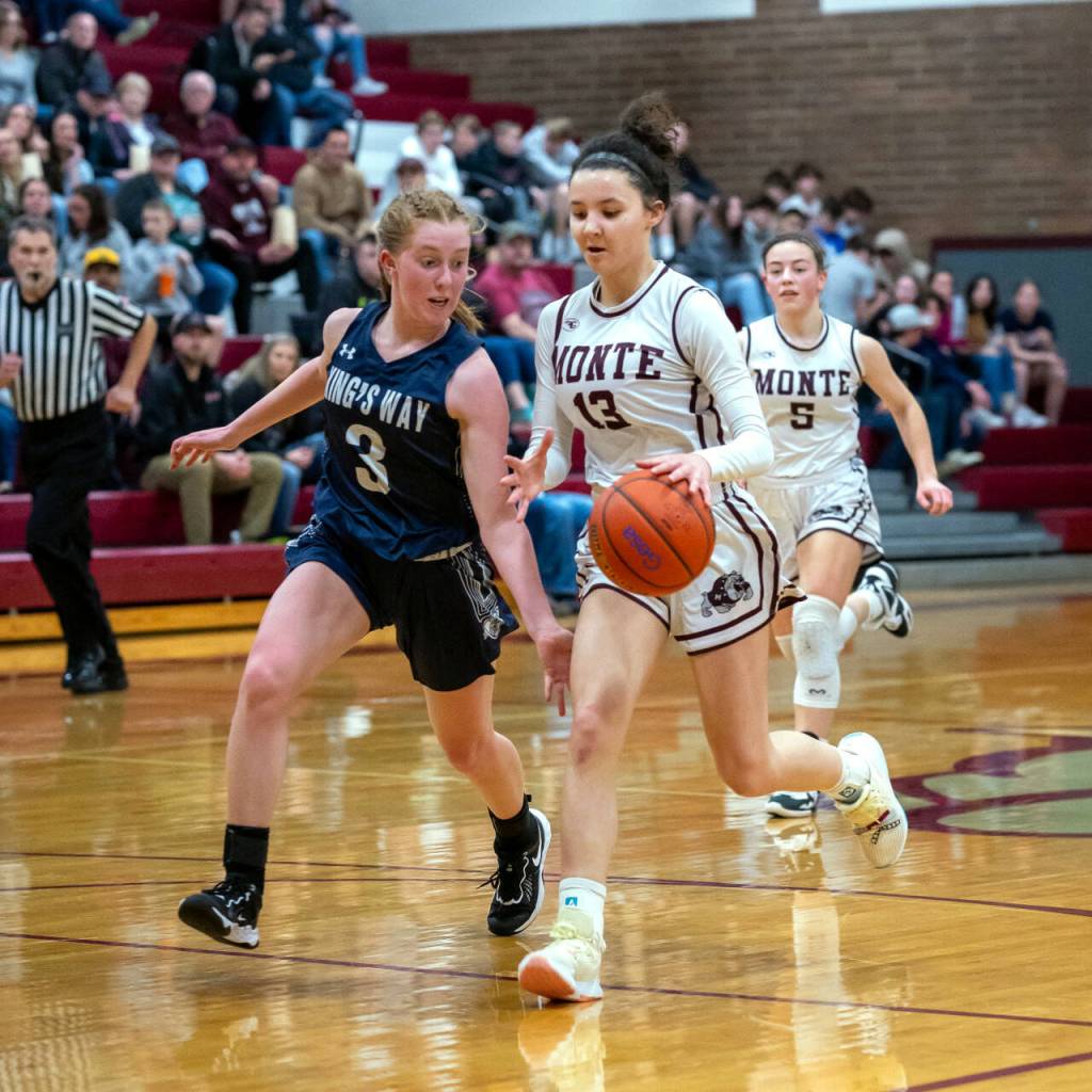 PHOTO BY FOREST WORGUM Montesano senior Maia Young (13) dribbles up court against Kings Way Christians Bridget Quinn during the Bulldogs 58-32 victory in a 1A District 4 semifinal game on Saturday in Montesano.