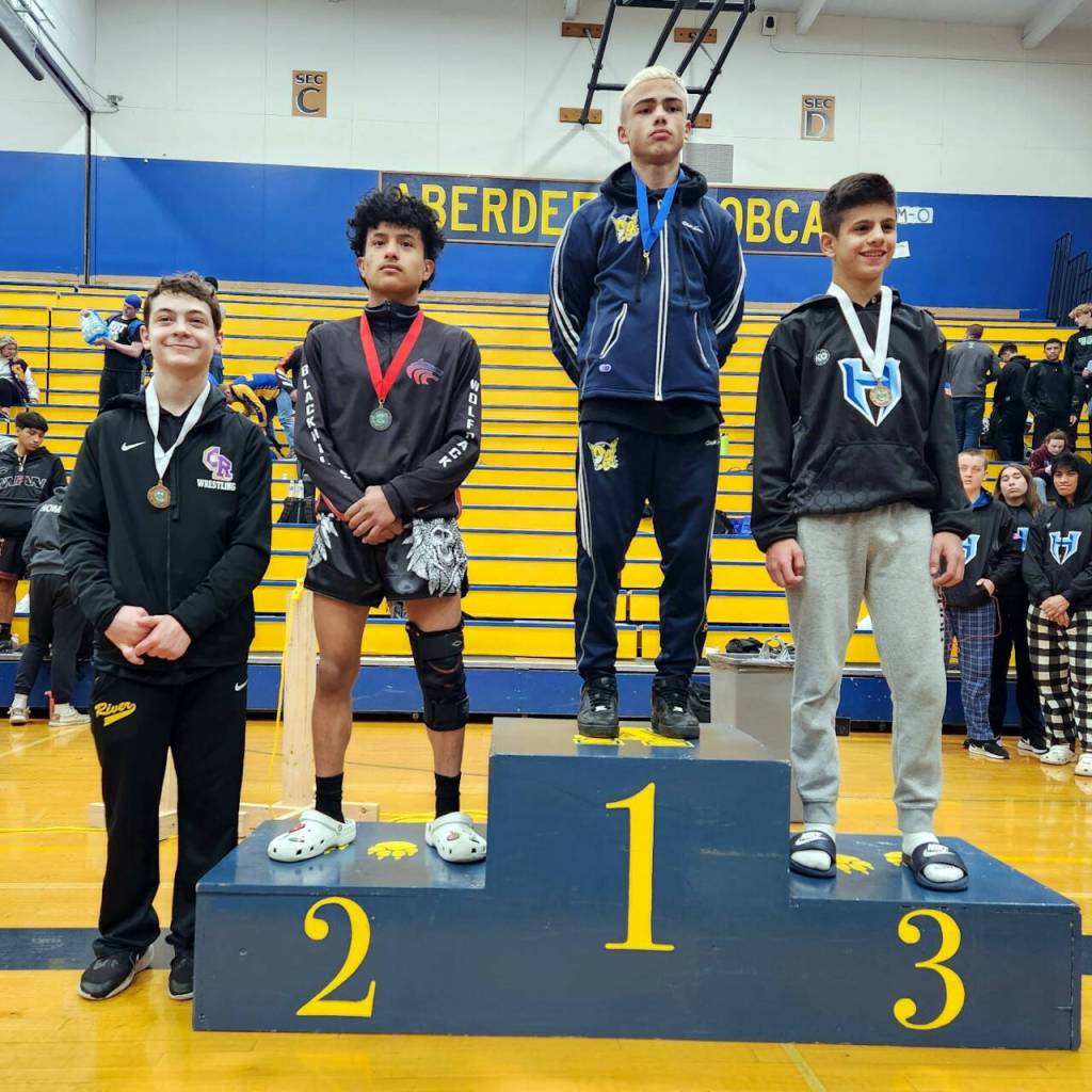 SUBMITTED PHOTO Aberdeens Talatheon Warness (1) stands atop the podium after winning the 106-pound championship at the 2A Region 3 Championships on Saturday in Aberdeen.