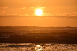 Matthew N. Wells / The Daily World 
As the sun sets and the toys are put away on Saturday evening, the sun looks ready to figuratively dunk itself underneath the surface of the Pacific Ocean and west of Ocean City Beach Access Area.