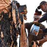 Clayton Franke / The Daily World
Ivan Hass, right, and Chris Hubbart dress the bear in oil prior to its burning on Saturday, Feb. 11.