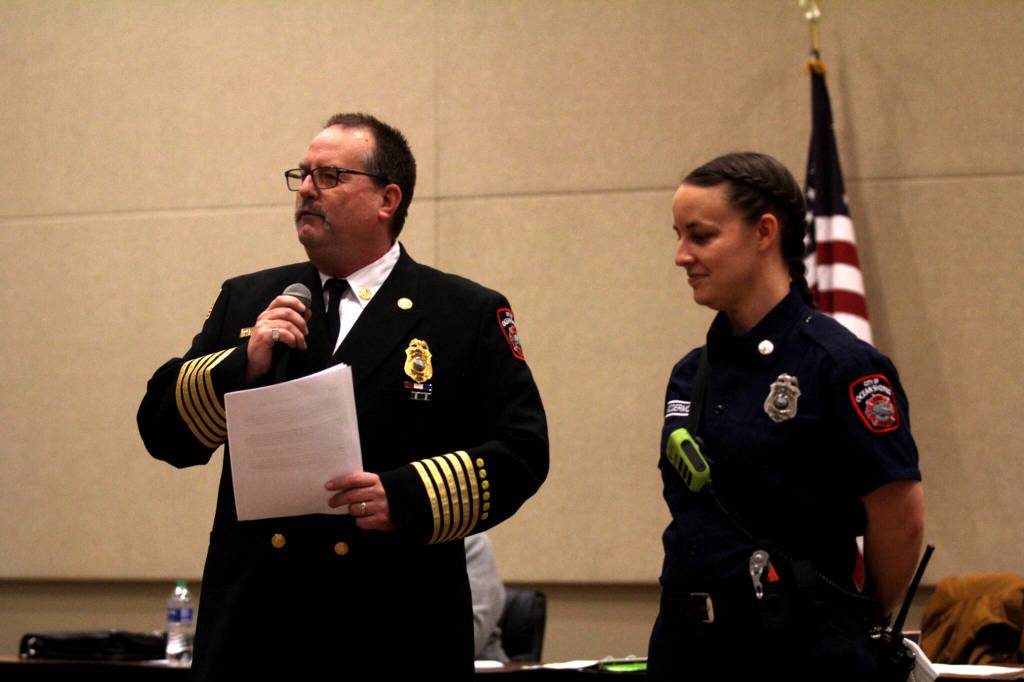 Ocean Shores Fire Chief Mike Thuirer, left, recognizes Kara McDermott, who was recently named the Veterans of Foreign Wars firefighter of the year by the local chapter, on Feb. 13. (Michael S. Lockett / The Daily World)