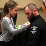 Sgt. Daniel Fode of the Ocean Shores Police Department is pinned by his daughter Dallas during a promotion ceremony on Feb. 13. (Michael S. Lockett / The Daily World)