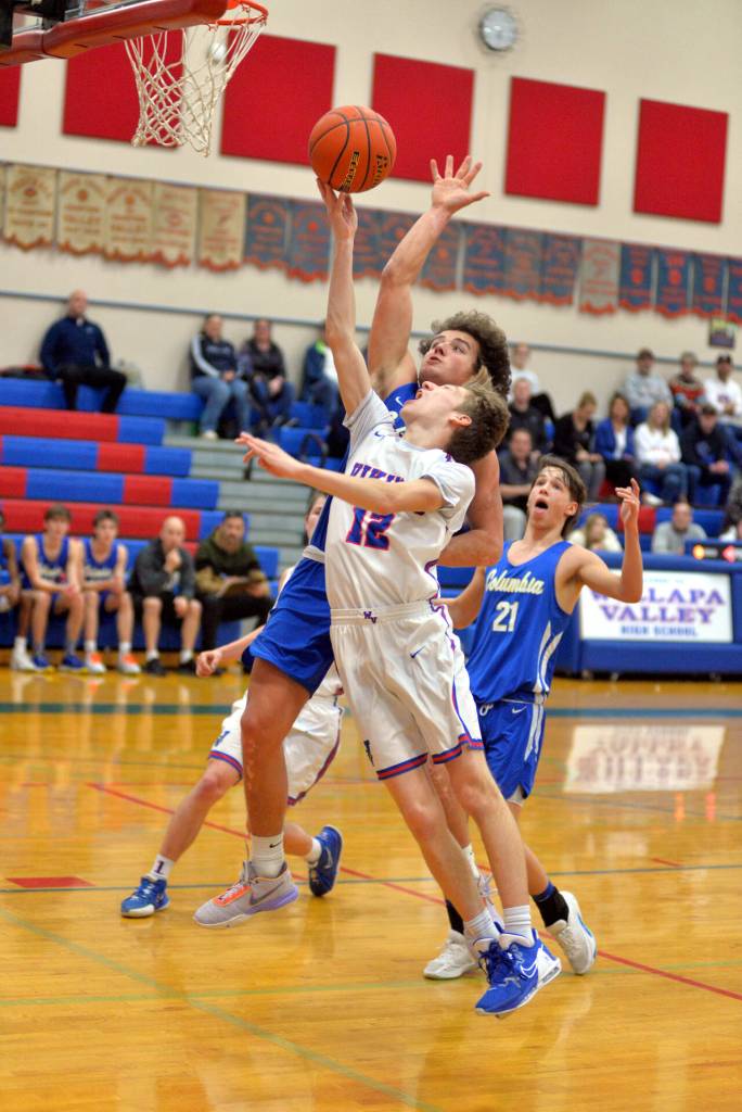 Willapa Valleys Nathan Fluke (12) attacks the basket during the Vikings 64-32 win over Columbia Adventist in a 1B District 4 semifinal matchup on Wednesday in Menlo.