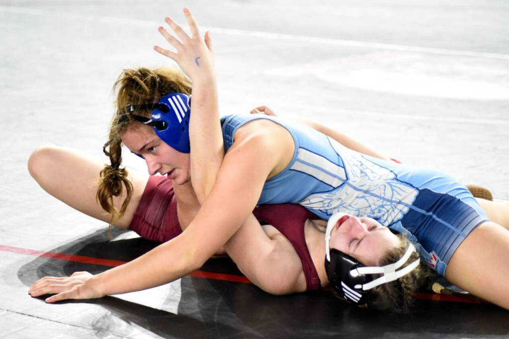 PHOTO BY SUE MICHALAK BUDSBERG Elma senior Hailee Stoken, top, works for a pinfall against W.F. Wests Lia Hornby during a girls 1A/1B/2A/2B 135-pound match at the Mat Classic XXXIV state-championship tournament on Friday at the Tacoma Dome.
