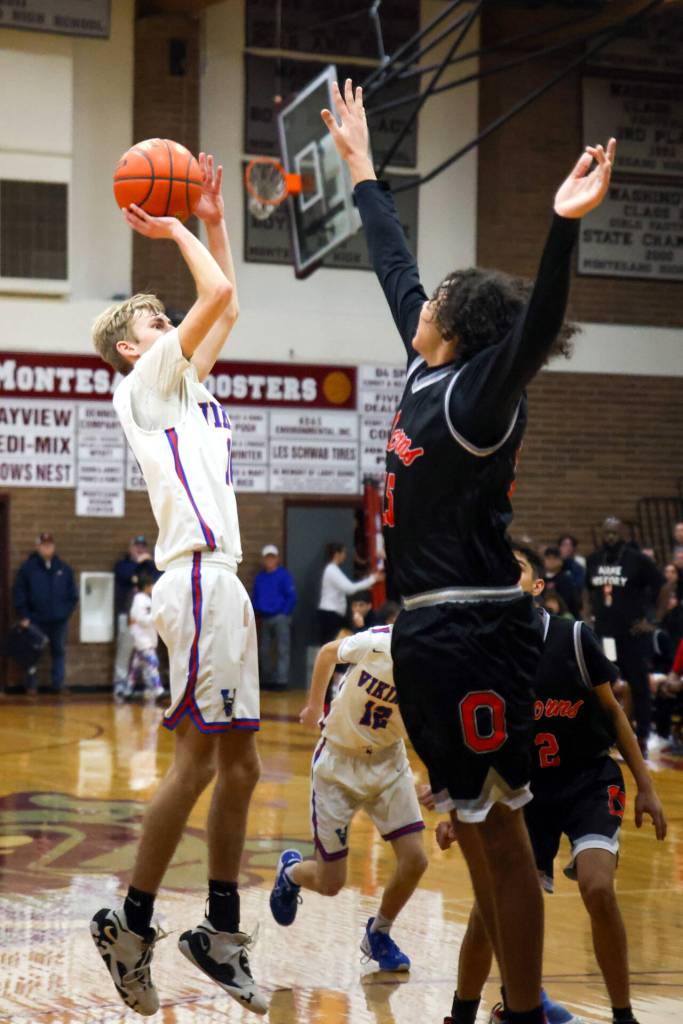 PHOTO BY LARRY BALE Willapa Valley senior Riley Pearson, left, puts up a jump shot during the Vikings 62-54 win over Oakville in the 1B District 4 Championship on Saturday at Montesano High School.