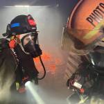 Chief Dennis Benn of the South Beach Regional Fire Authority, right, checks the temperature from a fire in an enclosed space during a firefighter academy in Westport on Feb. 18. (Michael S. Lockett / The Daily World)