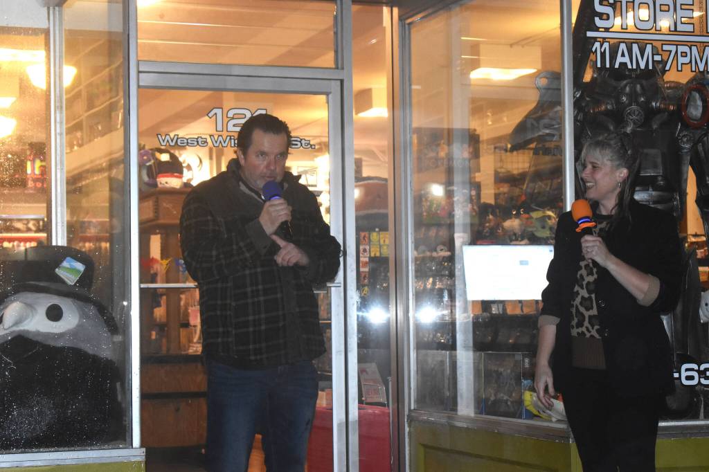 Lee Bacon, left, gives an introduction to the crowd, which built further excitement for the lighting of the Side One Building. The crowd was in attendance, across the street, to see the lighting of the building. Before and after the lighting, they received a chance to see a preview of the Kurt Cobain history that is featured inside the building. Days before, Dani Bacon, Lees wife, said her husband is a real showman. She was not wrong as the production involved in the lighting was similar to a Hollywood blockbuster.