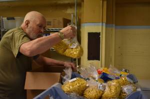 Clayton Franke / The Daily World
Steve Beck, a volunteer, packages pasta at the Salvation Army Food Bank in Aberdeen in December.