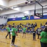 Attendees cheer as former Seattle Seahawks kicker Norm Johnson, (standing at free throw line) attempts to kick a basketball into the hoop during the team skills competition segment of the 11th annual Celebrity Basketball Game & Fundraiser at Aberdeen High School on Saturday, March 11. (Allen Leister / The Daily World)
