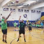 #51 Lofa Tatupu of the celebrity team attempts a 3-pointer against #1 Zachary Fitzgerald of the Grays Harbor Hawks Black Hawks lineup in the third game of the event. The Grays Harbor Hawks would defeat the celebrity team 51-40. (Allen Leister / The Daily World)