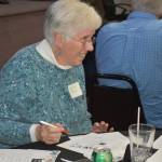 Marilee Rhoads, of Aberdeen, takes time to cast her vote on Tuesday night at 100+ Harbor Women Who Care. Rhoads said she hadnt heard of the group before its October 2022 event. I thought it was a really good idea to support local nonprofits.