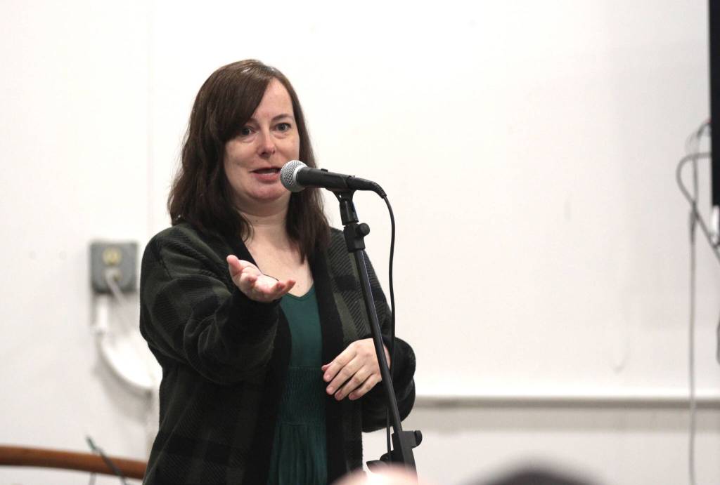 Left, Brandi Bednarik, executive director of the Grays Harbor Historical Seaport, speaks during a community event on March 25. Right, Carlos Osario of the Twin Harbors Waterkeepers translates presentations into Spanish during the event.