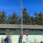 Barbara Hayford, left, executive director of the Coastal Interpretive Center, and volunteer Bob Krueger stand with the new Motus tower on Monday, March 27 at the interpretive center in Ocean Shores. (Clayton Franke / The Daily World)
