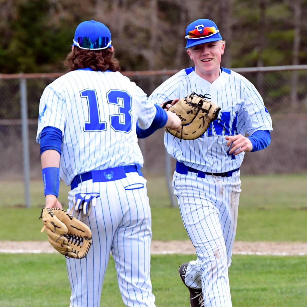PHOTO BY CHRYSTAL WELD Elmas Grant Vessey, right, and Gibson Cain high-five during the Eagles double header sweep over Hoquiam on Wednesday in Elma.