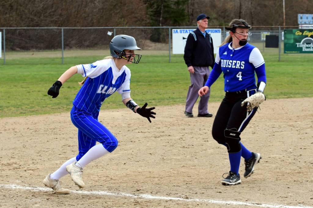 PHOTO BY CHRYSTAL WELD Elmas Aaleigha Weld, left, races home during the Eagles 15-2 victory over Eatonville on Wednesday in Elma.