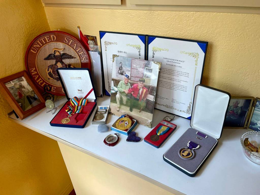 The decorations of Jim Evans, a Marine veteran of Korea and one of the Chosin Few, adorn a small shelf in his home.