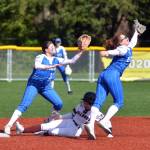 RYAN SPARKS | THE DAILY WORLD Montesanos Addi Kersker slides in to second base while Elmas Emmie Spencer, right, and Karly Rambo, left, defend during the Bulldogs 16-0 win on Tuesday in Montesano.