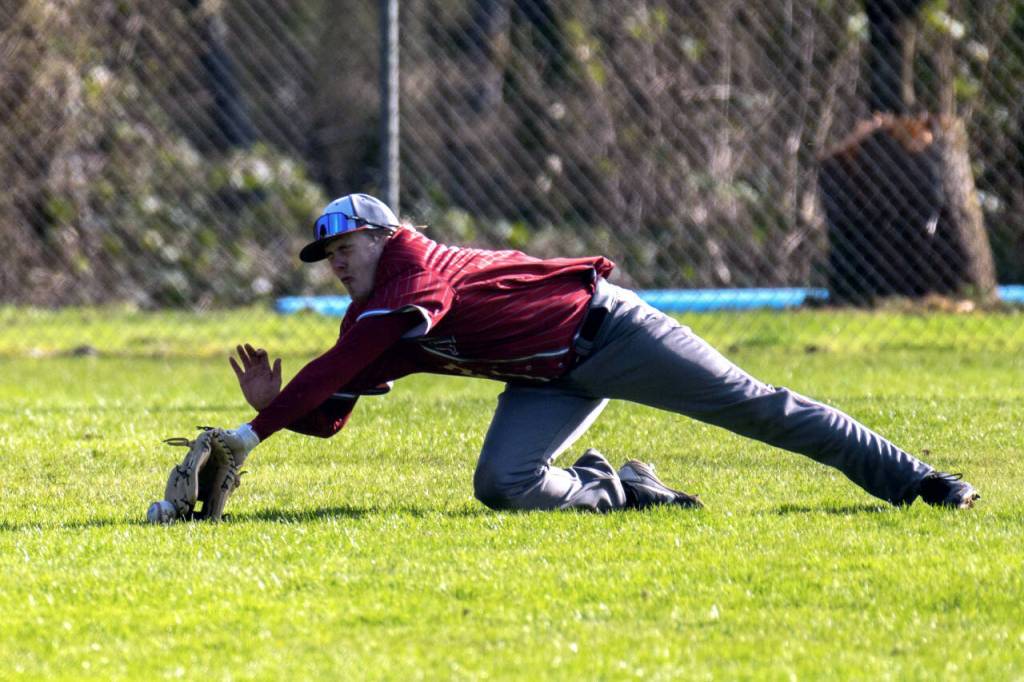 PHOTO BY FOREST WORGUM Hoquiam outfielder Ethan McLucas dives for a ball during a doubleheader loss to Montesano on Tuesday at Vessey Field in Montesano.