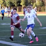 RYAN SPARKS | THE DAILY WORLD Montesano forward Felix Romero, left, chases down Eatonvilles Trentten Cressman during the Bulldogs 4-1 win on Wednesday in Montesano.