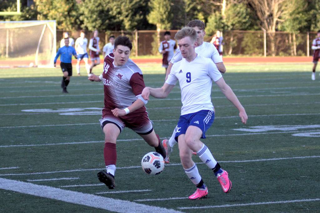 RYAN SPARKS | THE DAILY WORLD Montesano forward Felix Romero, left, chases down Eatonvilles Trentten Cressman during the Bulldogs 4-1 win on Wednesday in Montesano.