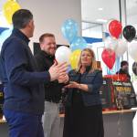 Damon Gleason and Allen Erickson, from left, who co-own Five Star Dealerships with Rich Hartman, stand with Kelley McDonald, executive director of United Way of Grays Harbor. All three people spoke glowingly of the job the 70 high school students did during a gala event in January. On Wednesday, the South Aberdeen dealership hosted Seattle Seahawks cornerback Tariq Woolen, who was in town to donate shoes to each one of the students.